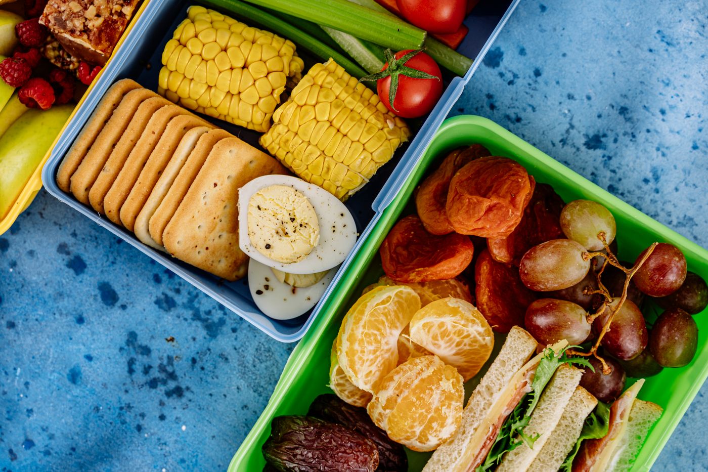 Packed lunch boxes illustrating the need for insulated storage and two cold sources for yogurt