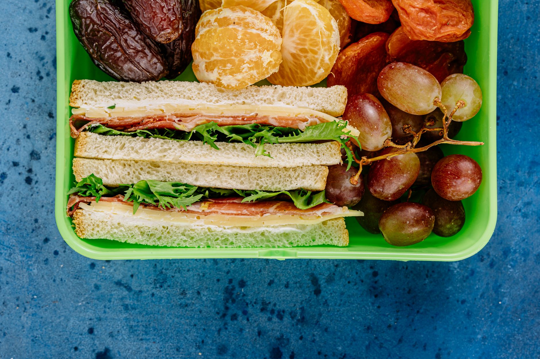 Assorted vintage picnic foods on a checkered blanket