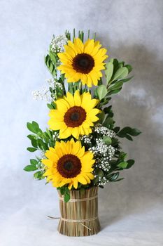 Bright sunflower arrangement in a rustic vase, perfect for cheerful decor.