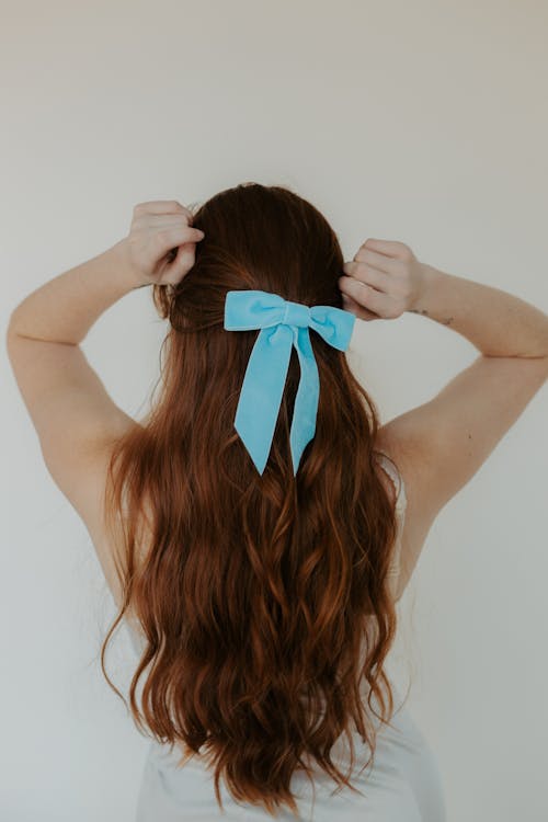 Woman with Blue Ribbon on Her Hair