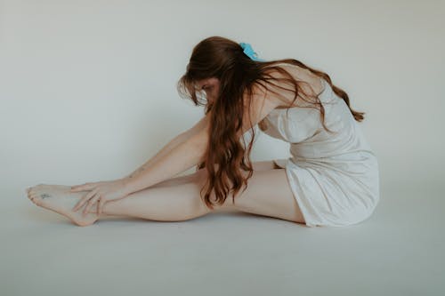 A Woman Stretching on the Floor