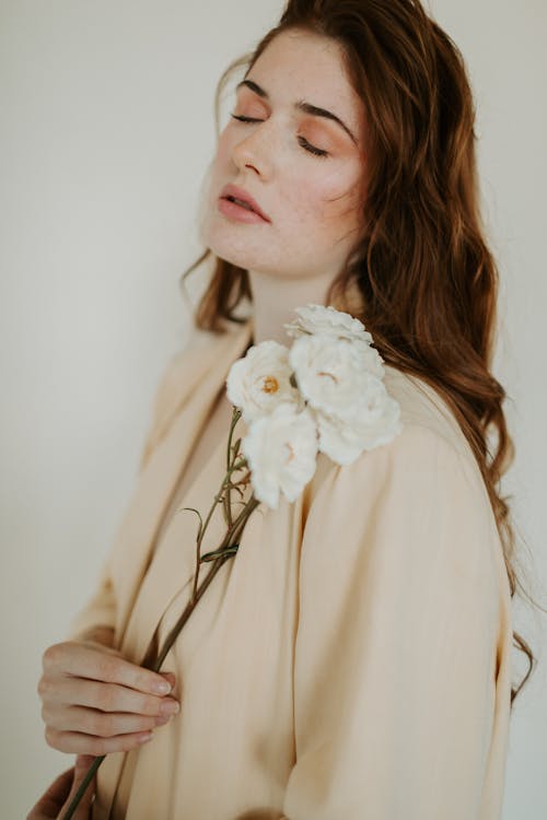 A Woman Holding White Flowers