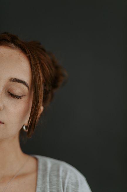 Intimate portrait of a woman with closed eyes, serene expression.