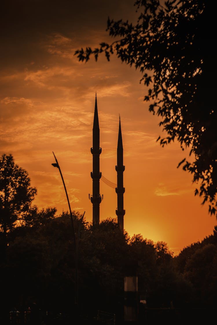 Minaret Silhouettes Against Orange Sunset