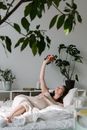 Woman Holding Peach in Bed