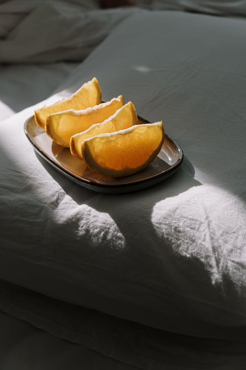Free Sliced Orange Fruit on a Ceramic Plate Stock Photo