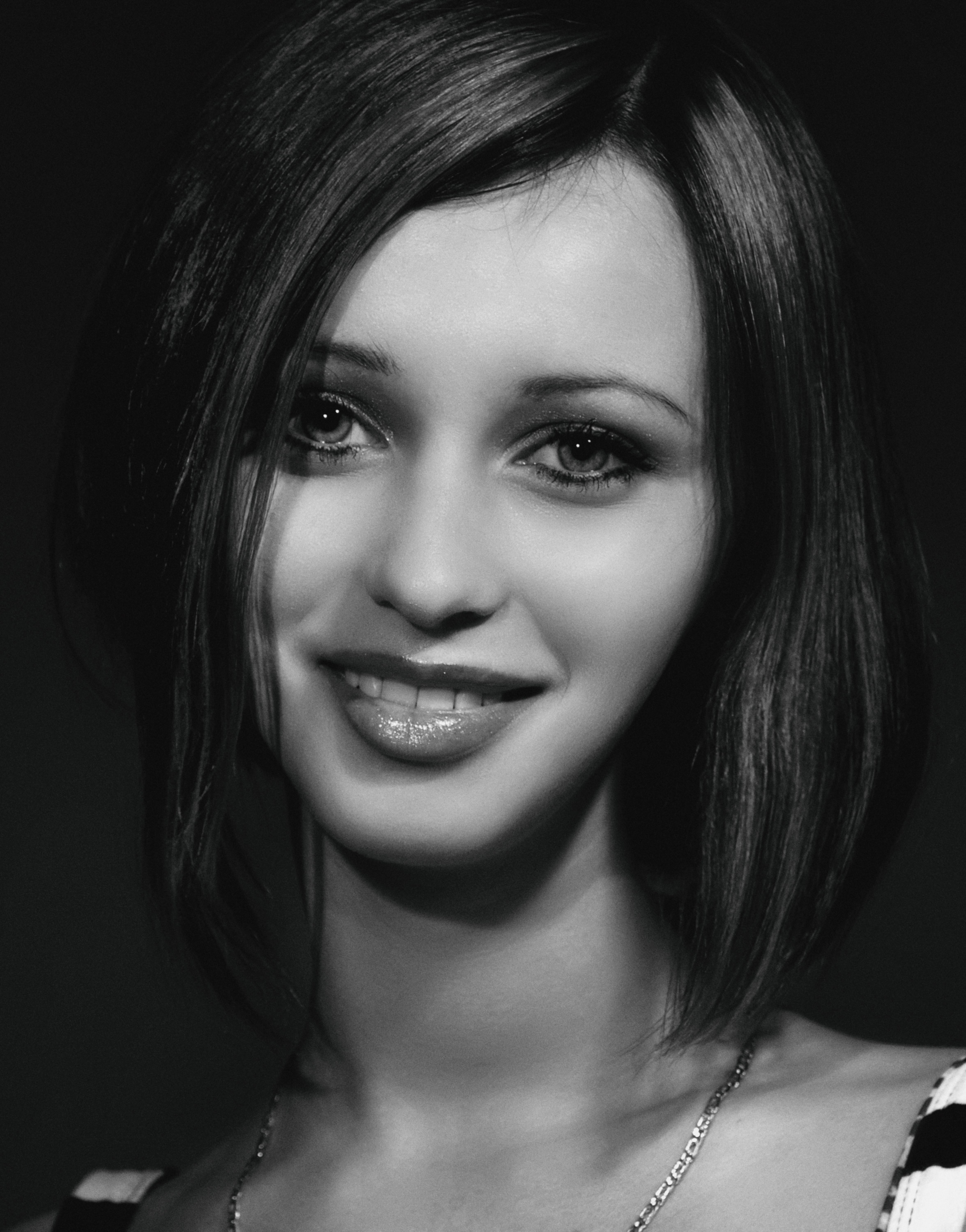 Black and white portrait of a smiling woman with short hair in Kyiv.