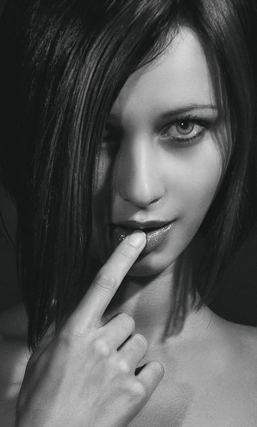Grayscale Portrait of a Woman with Her Finger on Her Lip