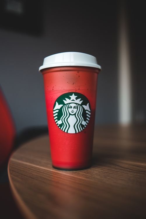 Free Plastic cup of tasty hot beverage placed on wooden table in coffee shop Stock Photo