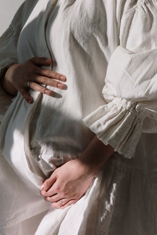 Free Hands of a Woman on Her Belly Stock Photo