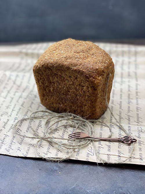 A Wheat Loaf of Bread over a Paper