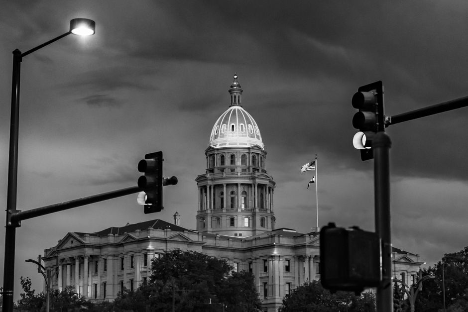 Is cabinet painting in Capitol Hill Denver worth it for small condos? 3 Dramatic black and white photo of the Colorado State Capitol at night with streetlights and stoplights.