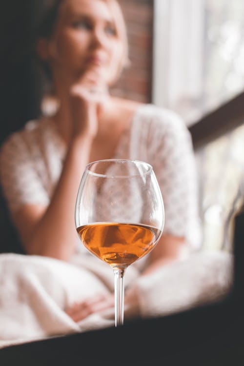 Free Wineglass and Woman in Background Stock Photo
