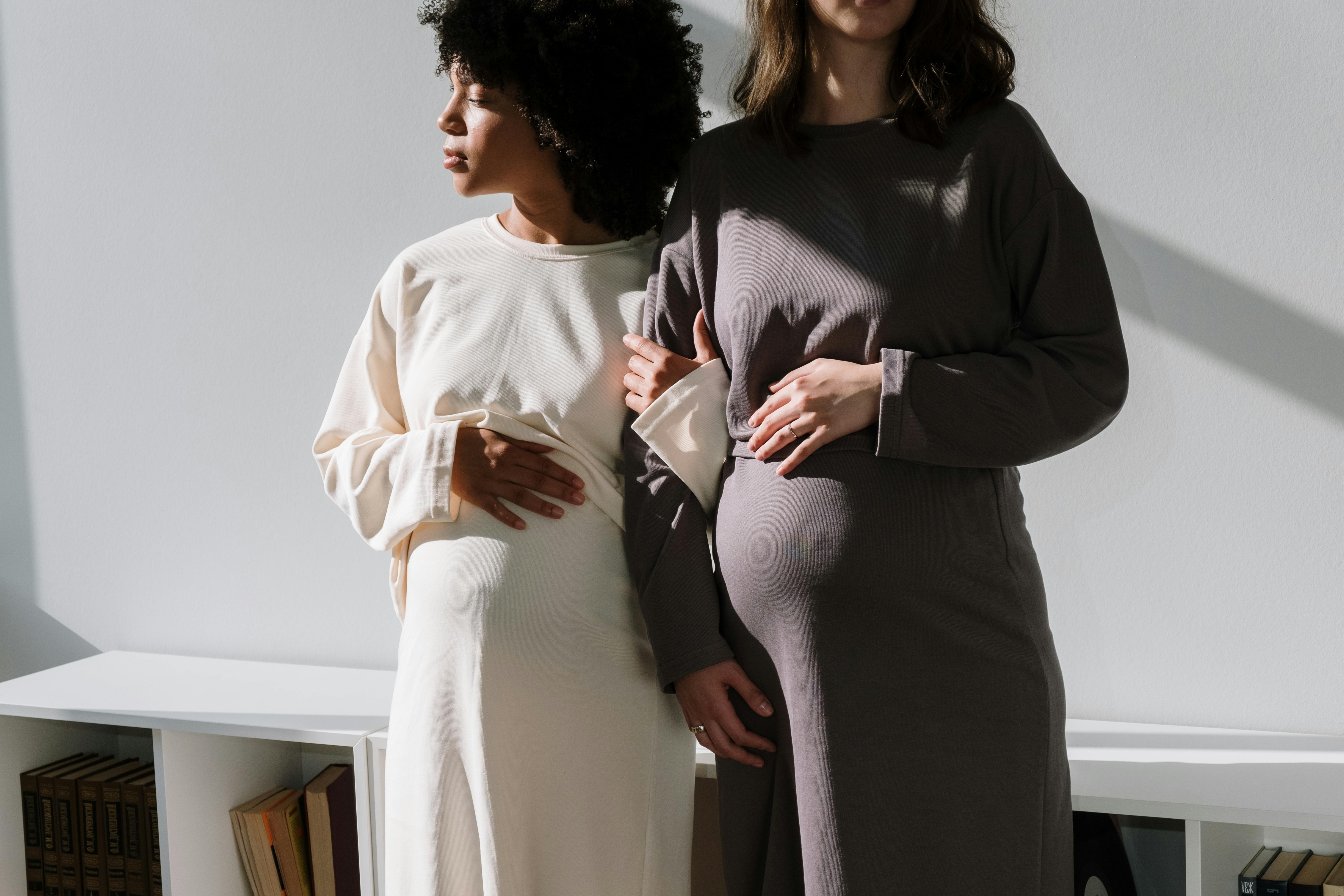 man in black long sleeve shirt kissing woman in white long sleeve dress