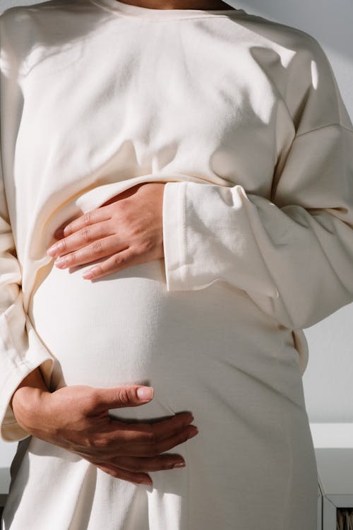 Free Pregnant Woman in White Long Sleeve Dress Stock Photo