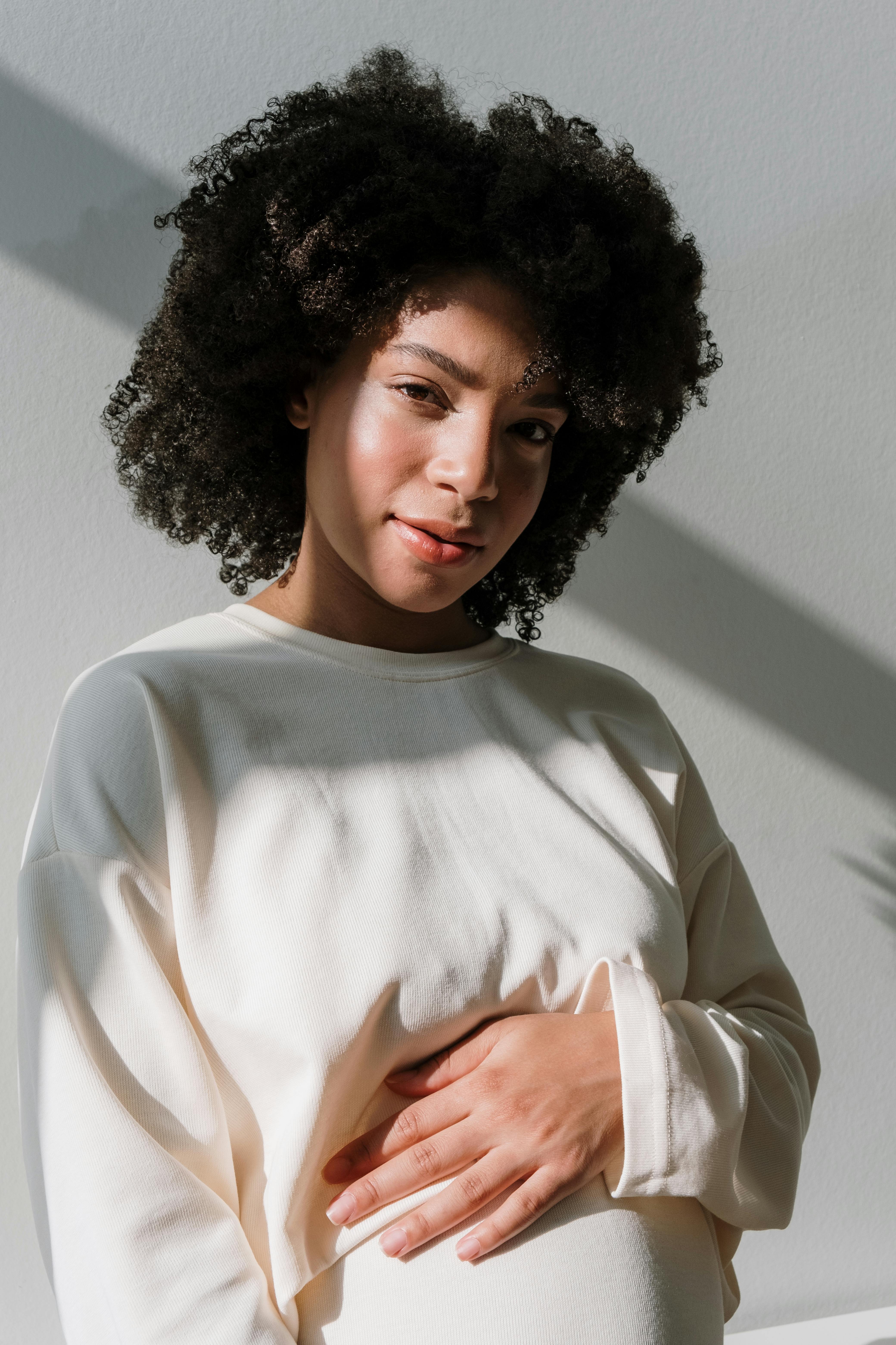 pregnant woman in white long sleeve dress