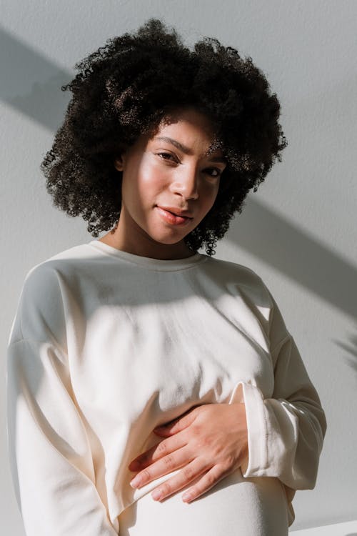 Pregnant Woman in White Long Sleeve Dress