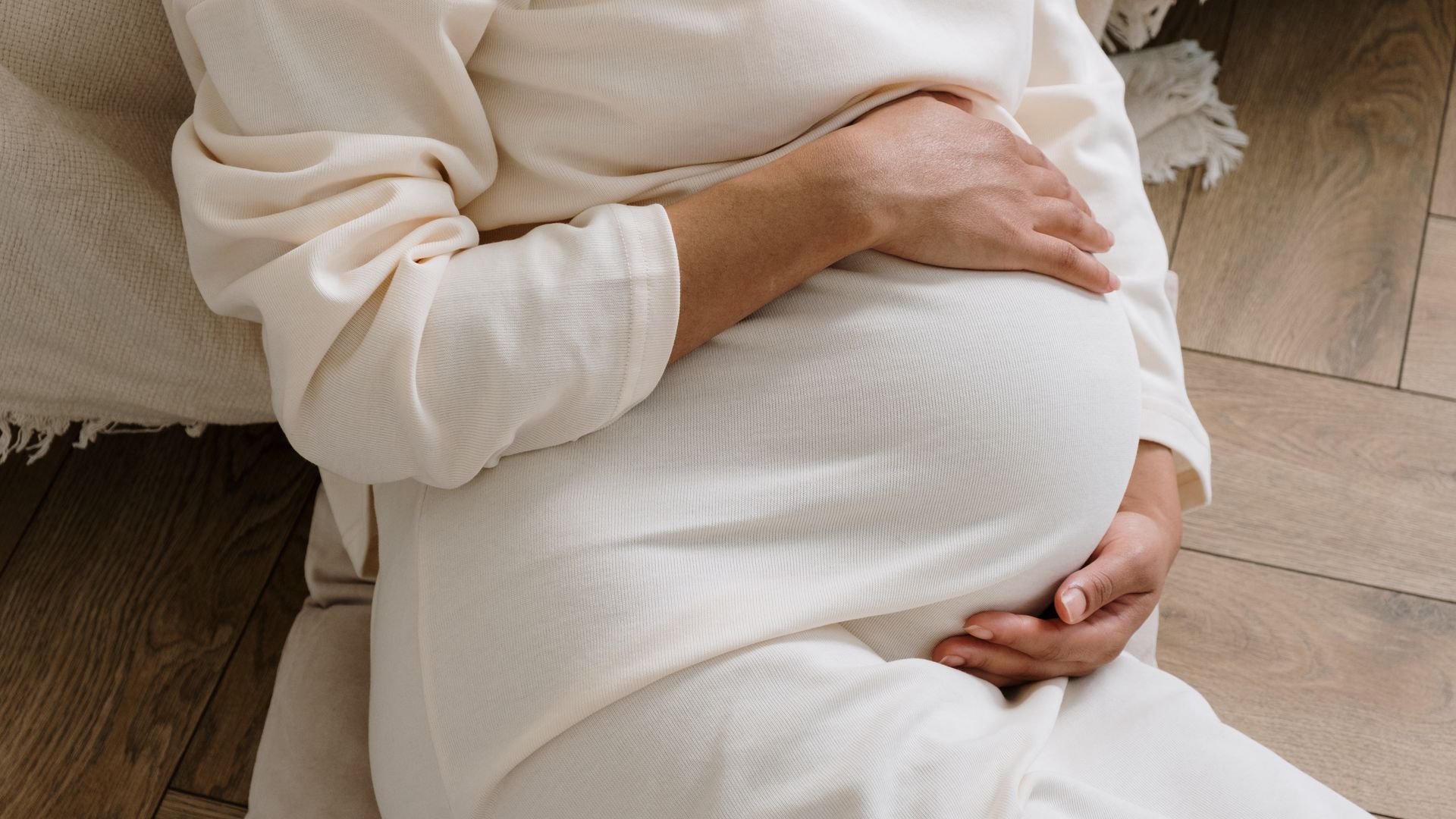 Modafinil Safety During Pregnancy: A Comprehensive Overview A serene moment of a pregnant woman in a cozy white dress holding her belly — modafinil safety during pregnancy