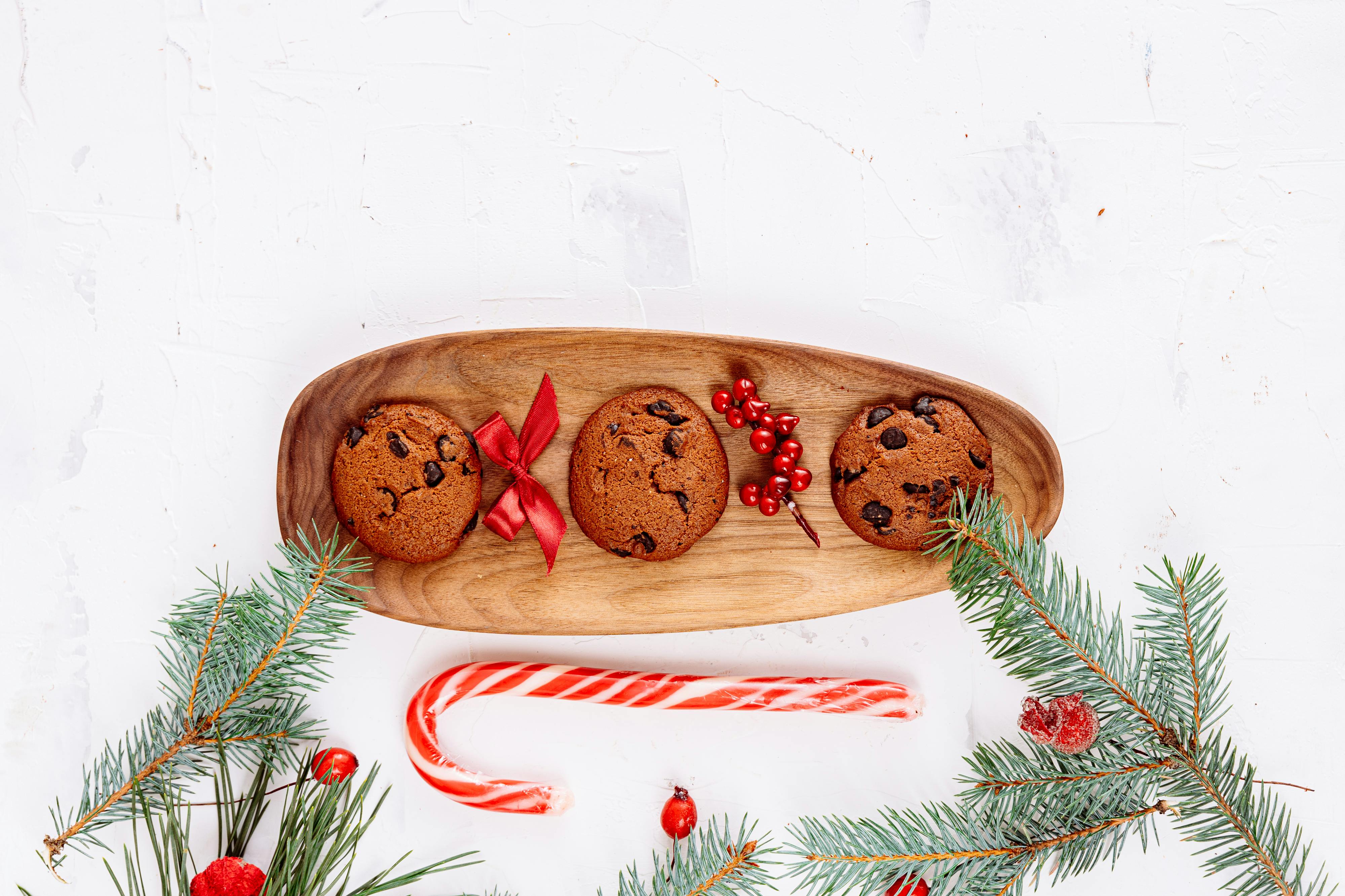 Top view of chocolate chip cookies with a candy cane arrangement, perfect for holiday decor.