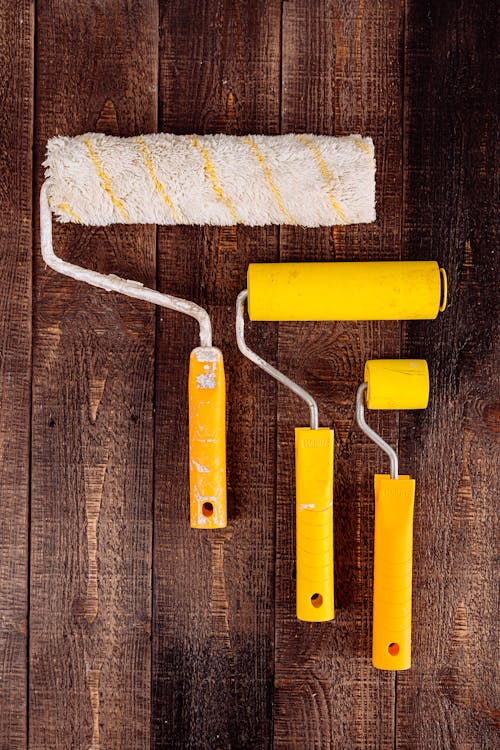 Free Paint Rollers on Wooden Table Stock Photo