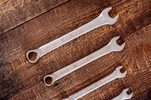 Metal Wrenches on Wooden Table