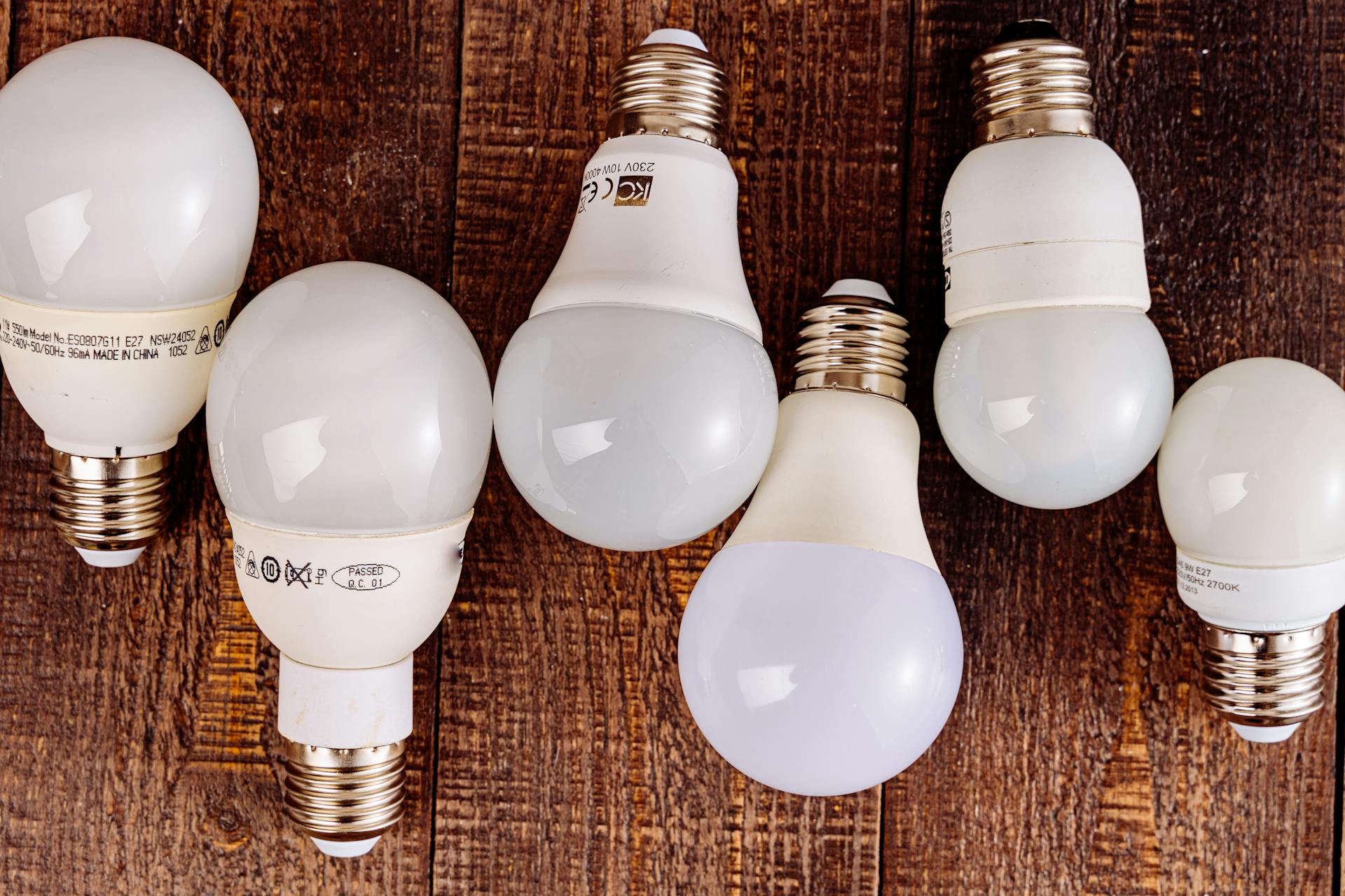 LED light bulbs arranged on a wooden surface, showcasing their modern design.