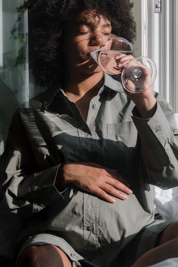 Pregnant Woman Drinking A Glass Of Water 