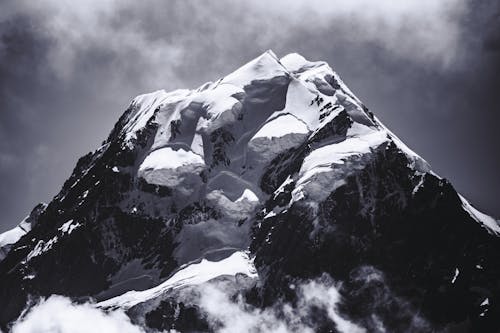 Grayscale Photo of Snow Covered Mountain