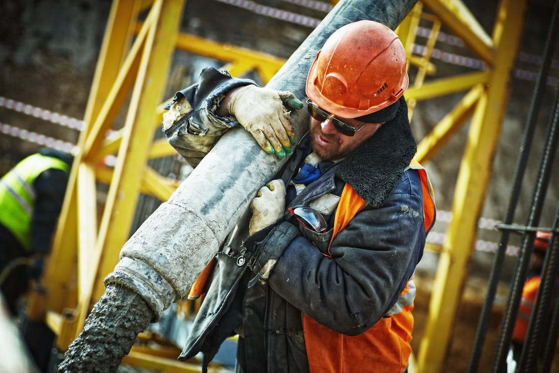 Free Man Carrying Gray Pipe Stock Photo