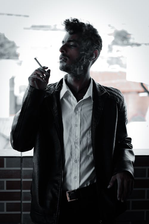 Free Man in Black Jacket Smoking Cigarette Stock Photo