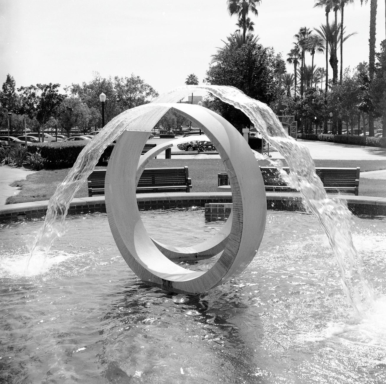 Monochrome shot of a modern water fountain in a sunny park in Rancho Cucamonga, CA.