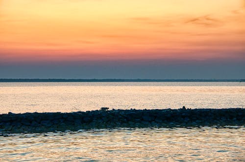 Scenic sunset sky over waving sea