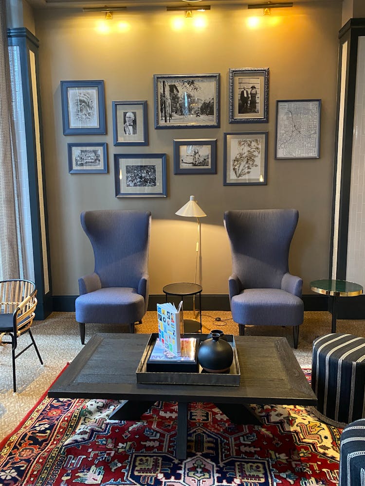 Armchairs Under Wall With Family Photos