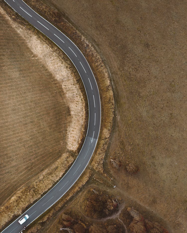 Top View Of A Car Traveling On Country Road