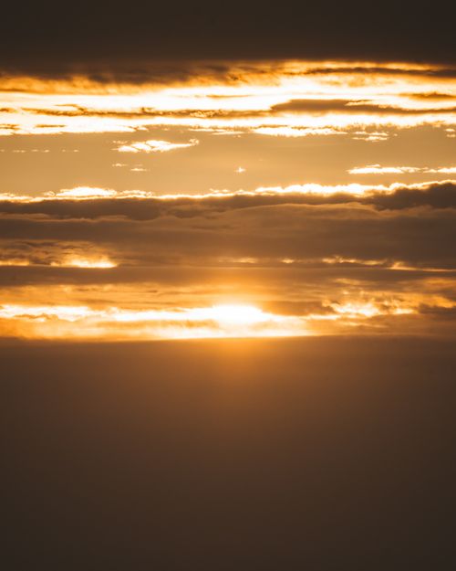 Free Bright sun shining horizon on sky with clouds above mountainous terrain at sundown time in nature in evening time Stock Photo