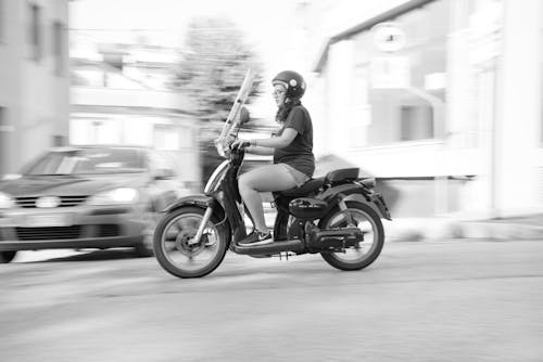 Free Woman Riding on Scooter Motorcycle Stock Photo