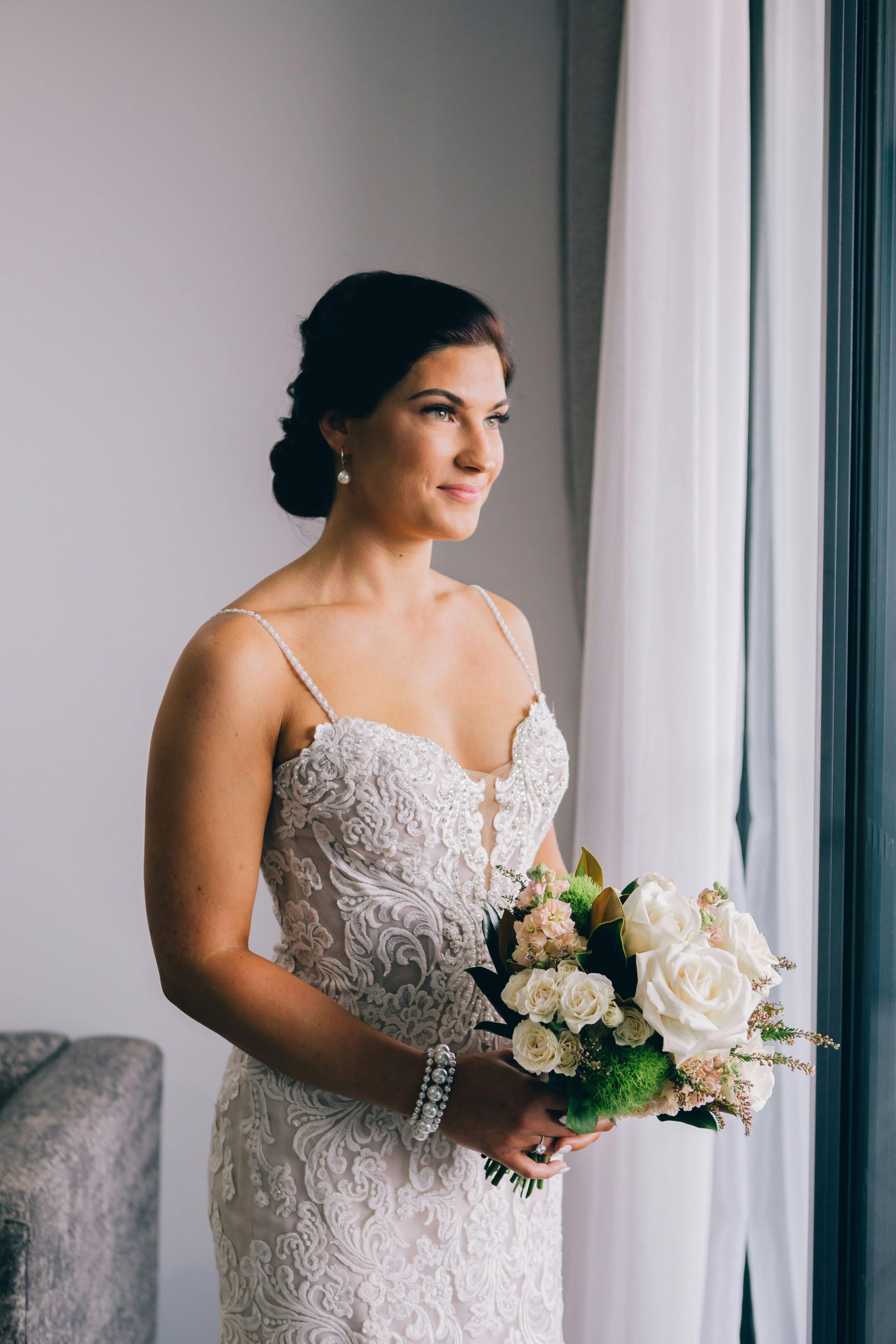 A Bride Holding a Bridal Bouquet · Free Stock Photo