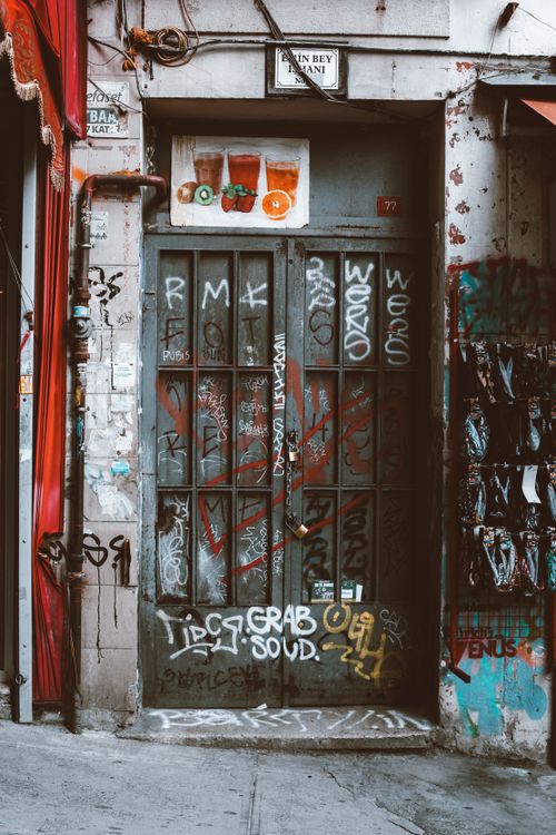 Free Abandoned building entrance with graffiti in an urban setting, showcasing street art. Stock Photo