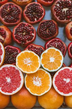 Colorful close-up of sliced citrus fruits and pomegranates showcasing freshness and healthy eating.