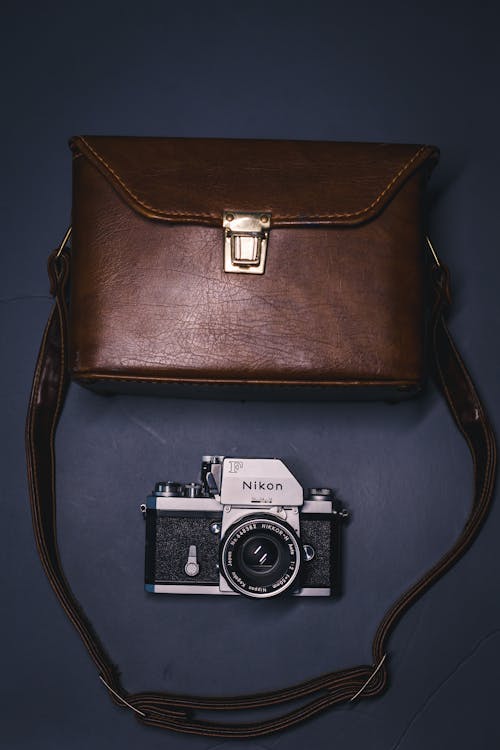 A Brown Leather Bag and a Camera 