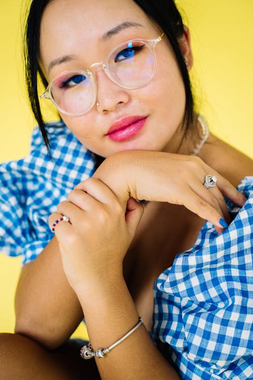 Close-Up Shot of Woman in Blue and White Checkered Dress Shirt Wearing Clear Framed Eyeglasses