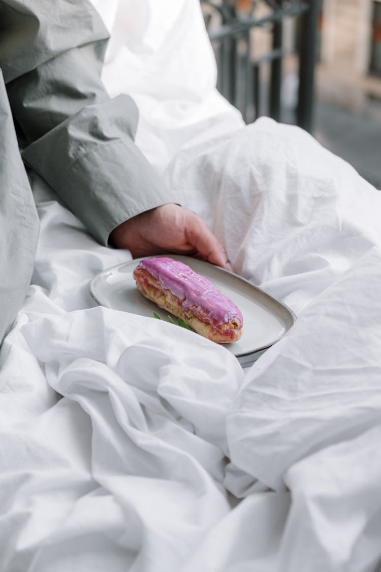 A Tasty Pink Eclair On A Plate