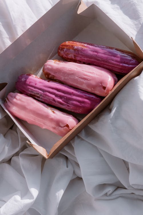 Lilac Colored Eclair Pastries in a Paper Box