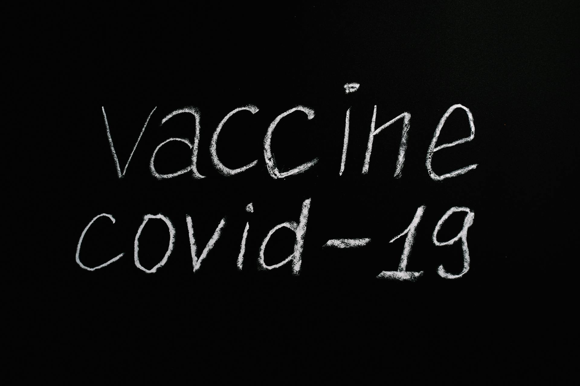 Vaccine Covid-19 Lettering Text on Black Background