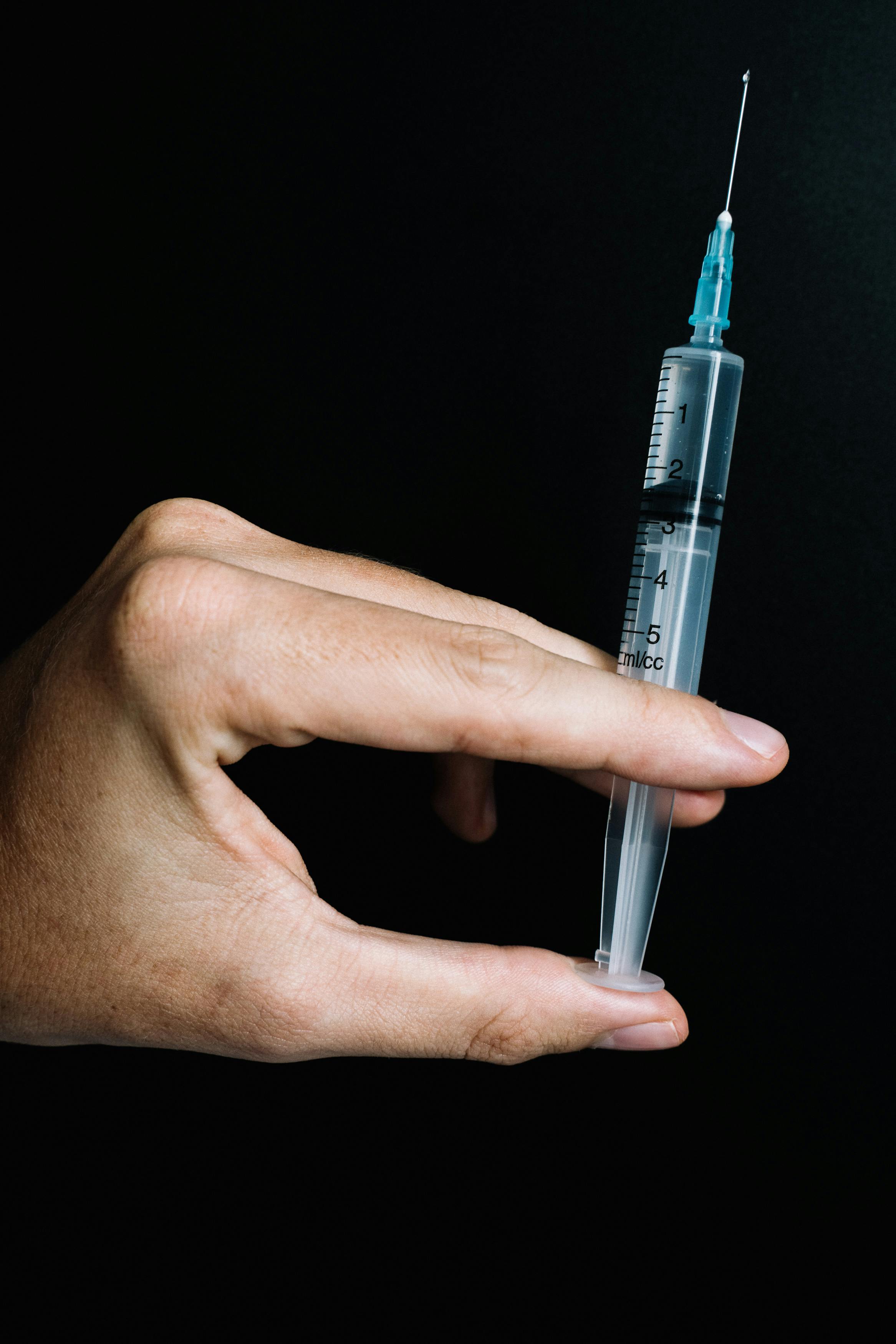 person holding a syringe
