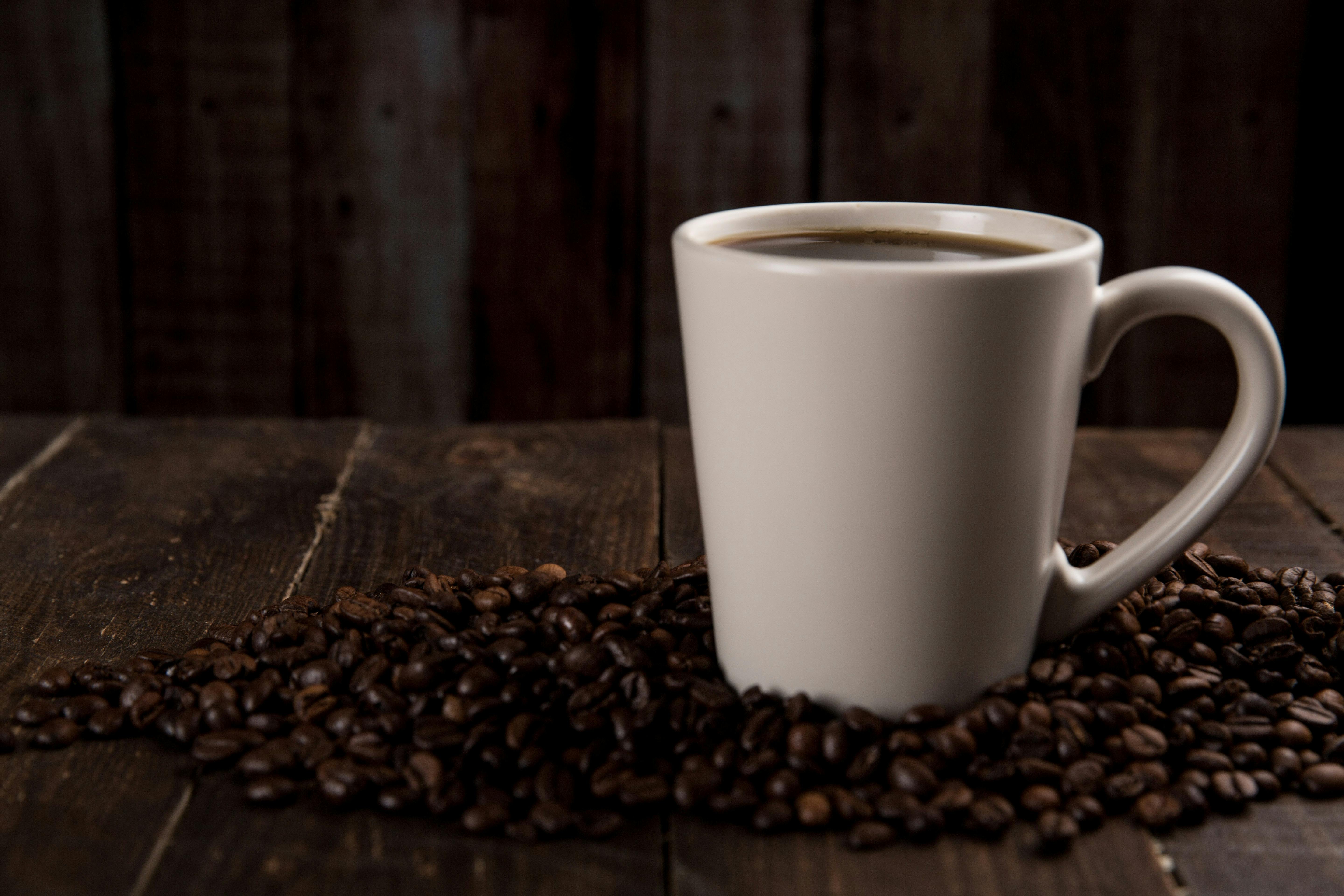 coffee-mug-surrounded-with-coffee-beans-free-stock-photo