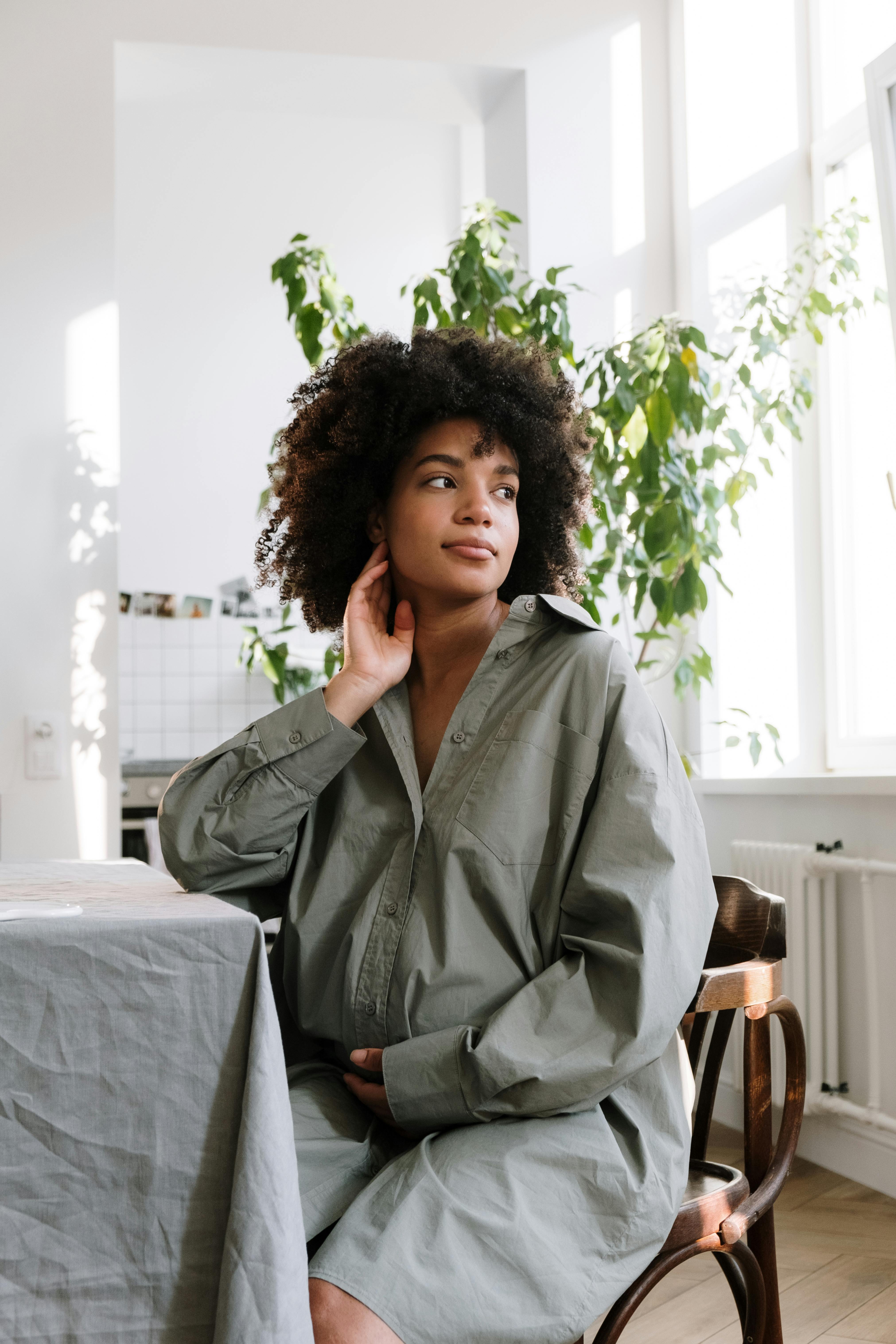 woman in gray coat sitting on chair