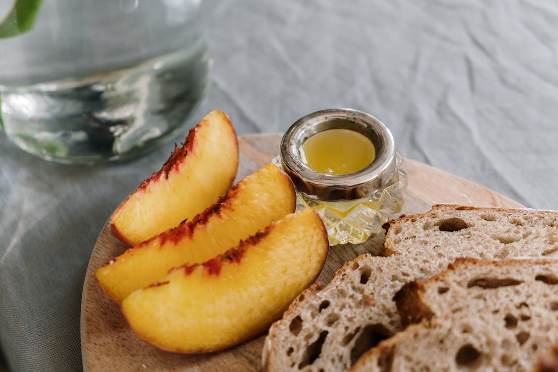 Free Slices of Peach and Bread on a Cutting Board Stock Photo