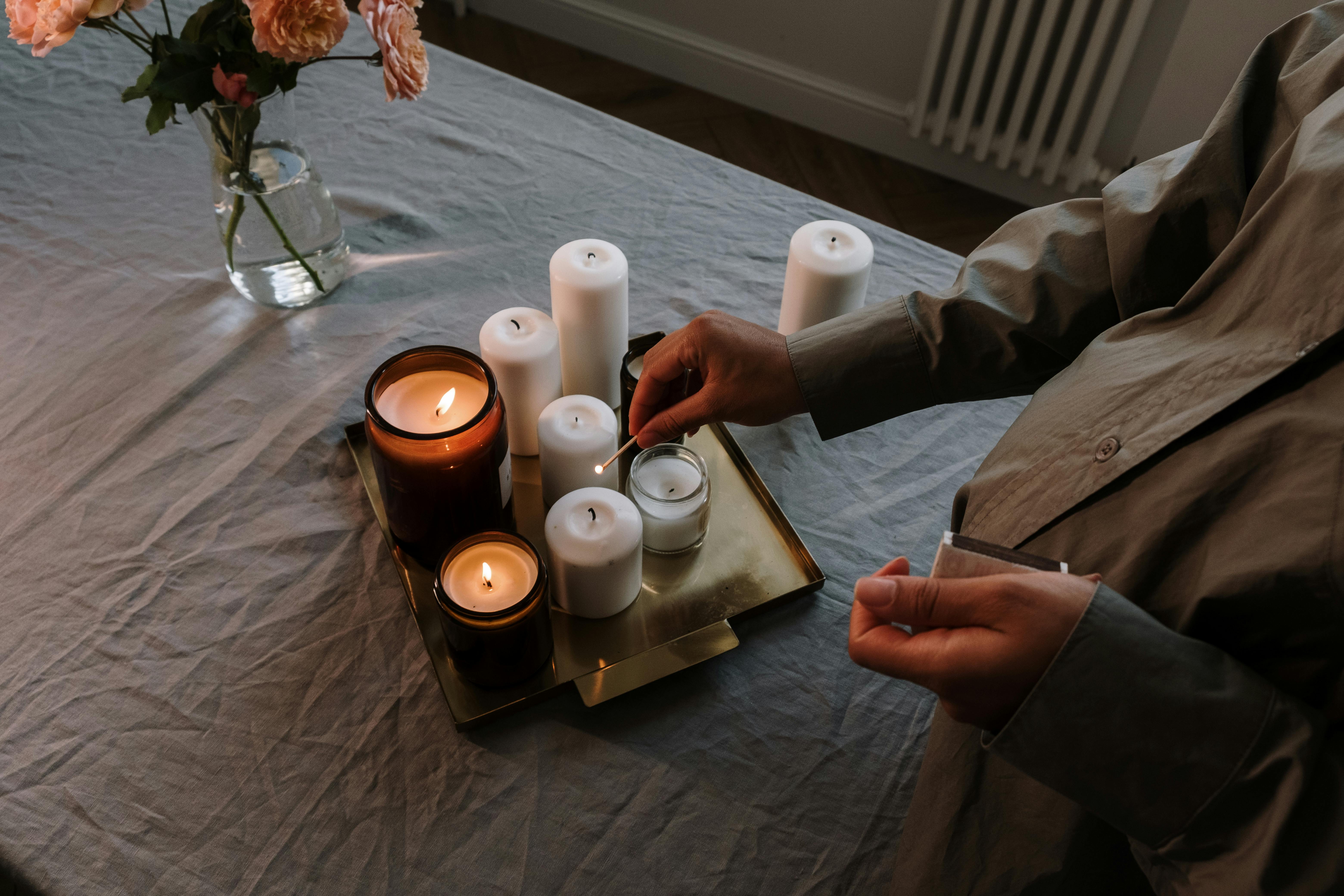 3 white pillar candles on brown wooden tray