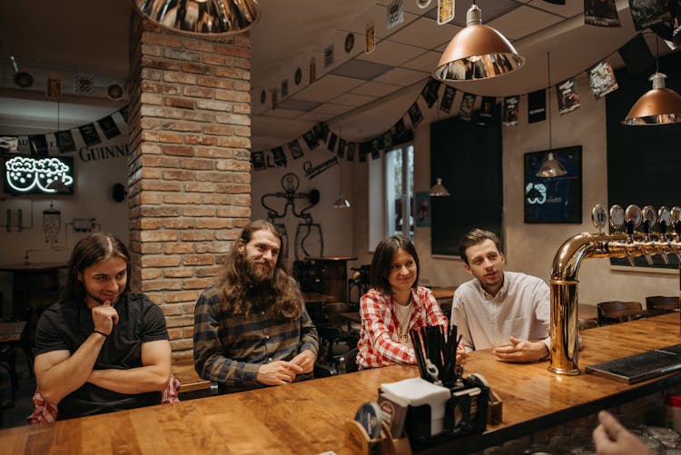 Friends Sitting At The Bar Counter